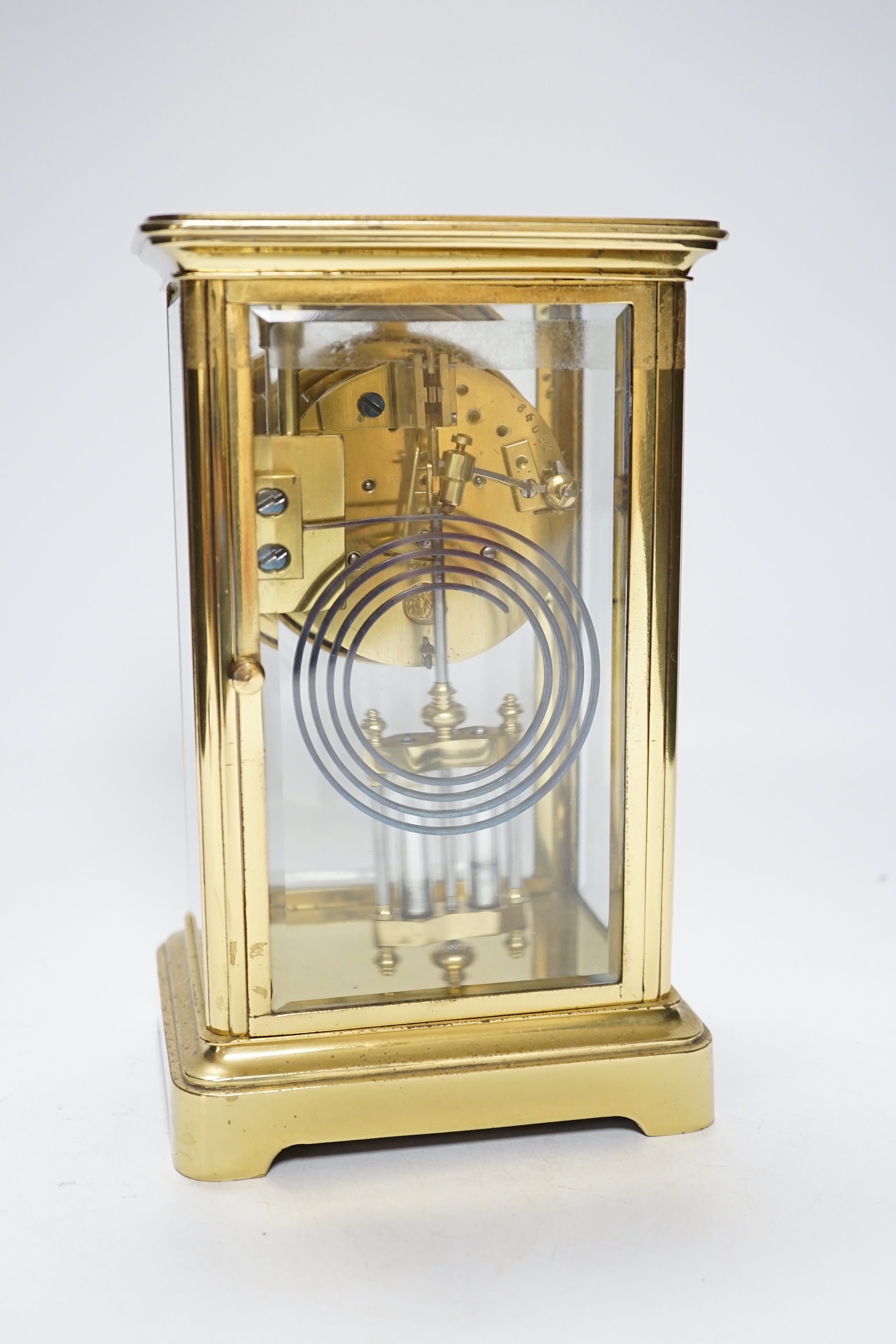An early 20th century brass four glass clock retailed by Dent, 22cm